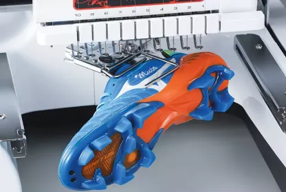 Blue and red shoe in embroidery machine